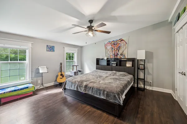a bedroom with a bed and a chandelier