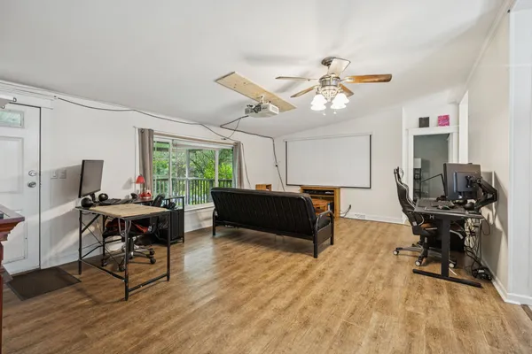 a living room with furniture a window and a piano