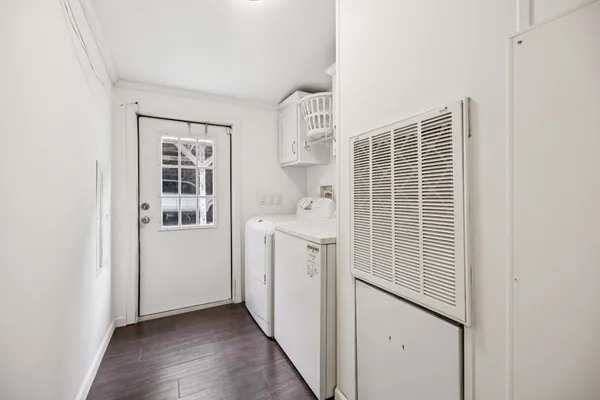 a utility room with cabinets washer and dryer