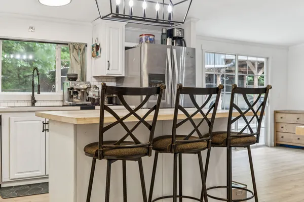 a kitchen with a table chairs and entryway