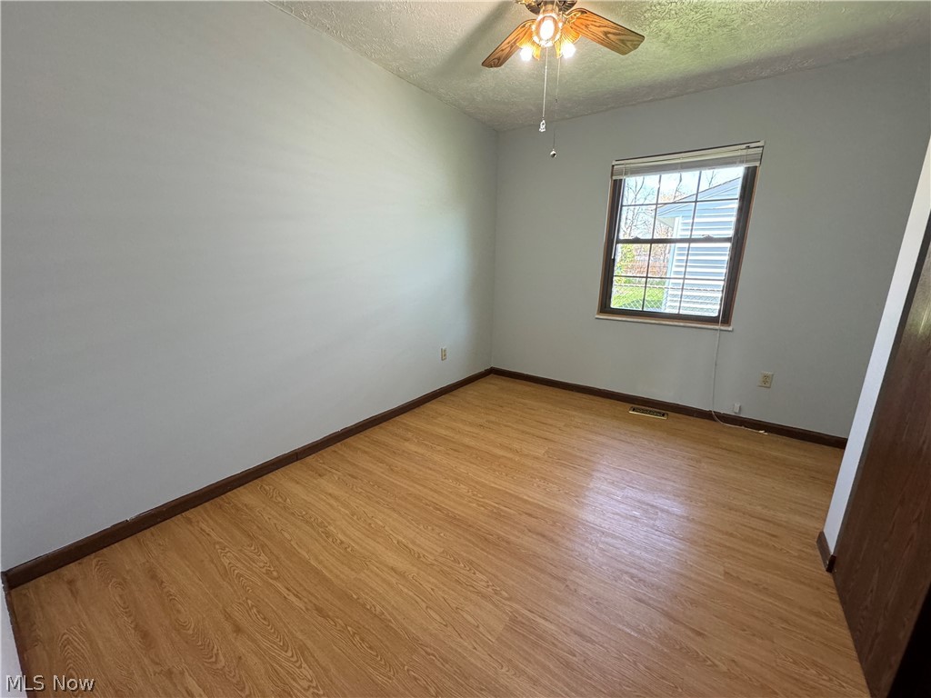 1763 Aberdeen Road Madison, OH 44057 - Photo 23 of 31 Empty room featuring wood-type flooring, and ceiling fan
