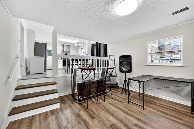 a view of entryway livingroom and hall with wooden floor