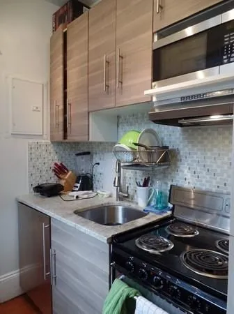 a kitchen with stainless steel appliances granite countertop a sink and a stove