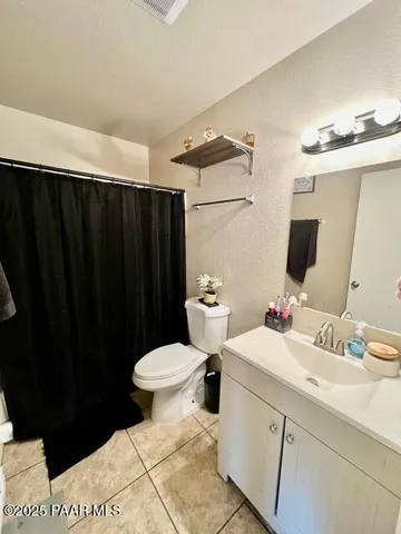 a view of a hallway with wooden shelves