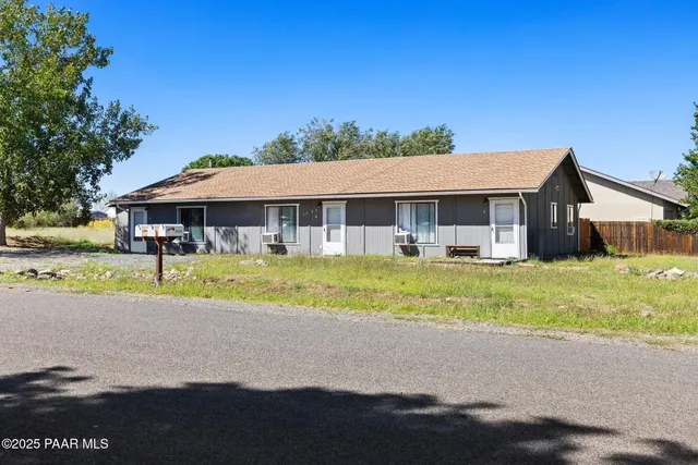 a view of house with a garden and a patio