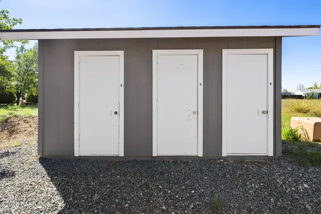 a living room with furniture a bookshelf and a window