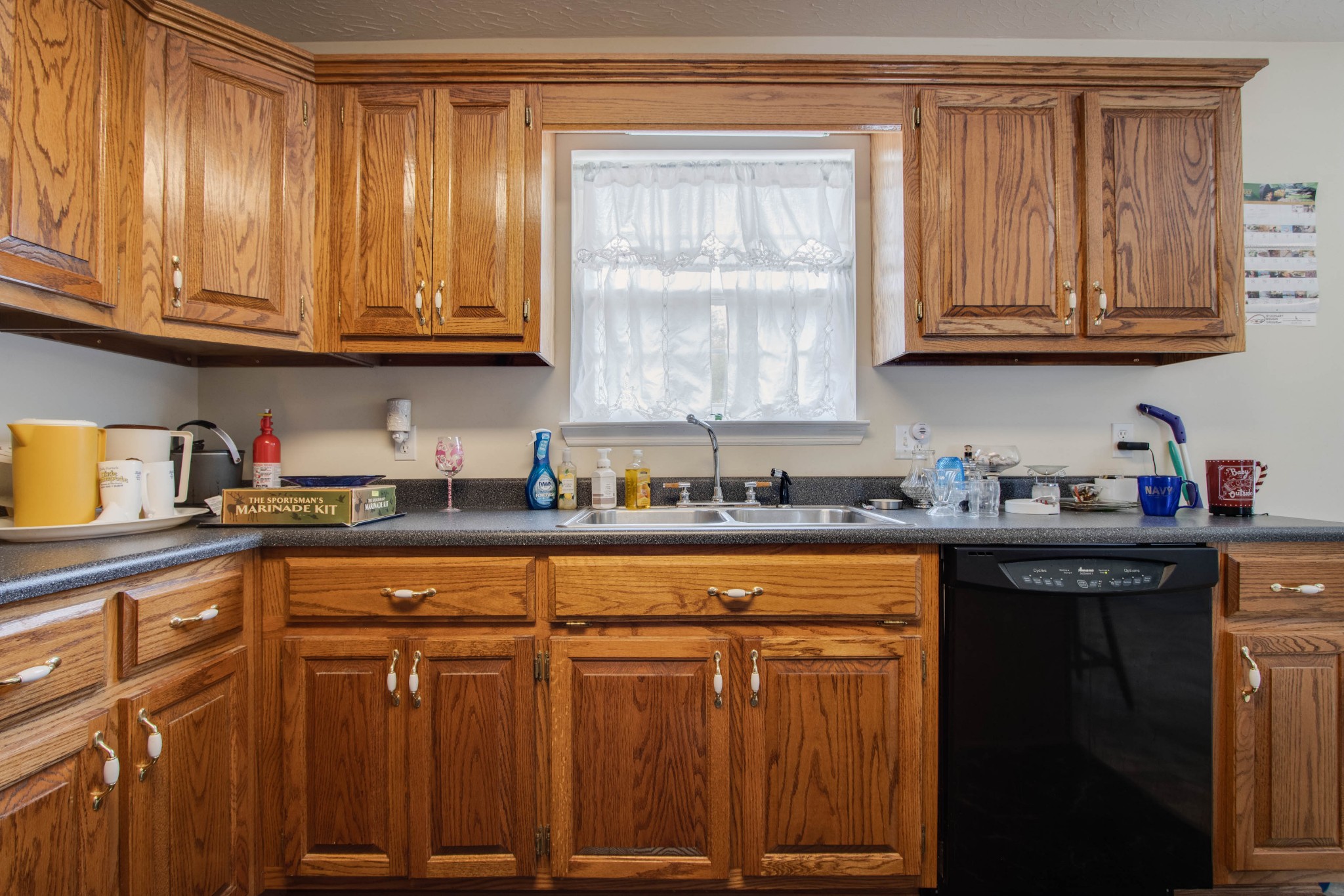 423 Ferguson Hill Road Lafayette, TN 37083 - Photo 23 of 63 a kitchen with granite countertop wooden cabinets a sink and dishwasher