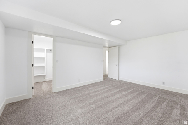 871 Bonita Way Centerville, UT 84014 - Photo 41 of 61 Spacious room featuring light gray carpeting, white walls, white baseboards, and a flush-mount ceiling light