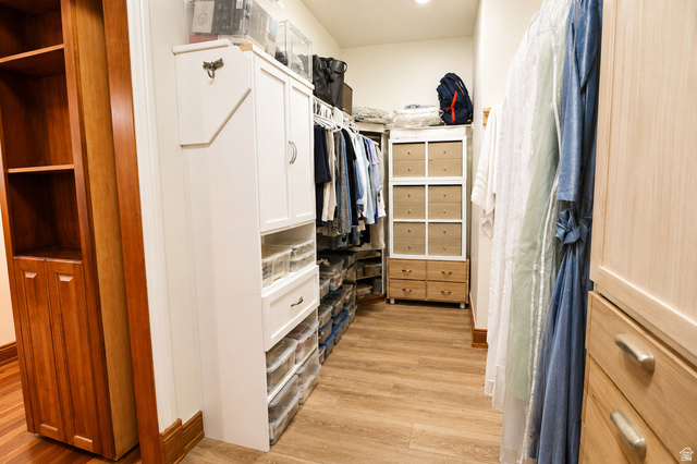 1055 North 1000 East Mapleton, UT 84664 - Photo 11 of 112 Walk-in closet featuring extensive built-in cabinetry, wood-finish flooring, recessed lighting, and a blend of white and natural wood storage solutions