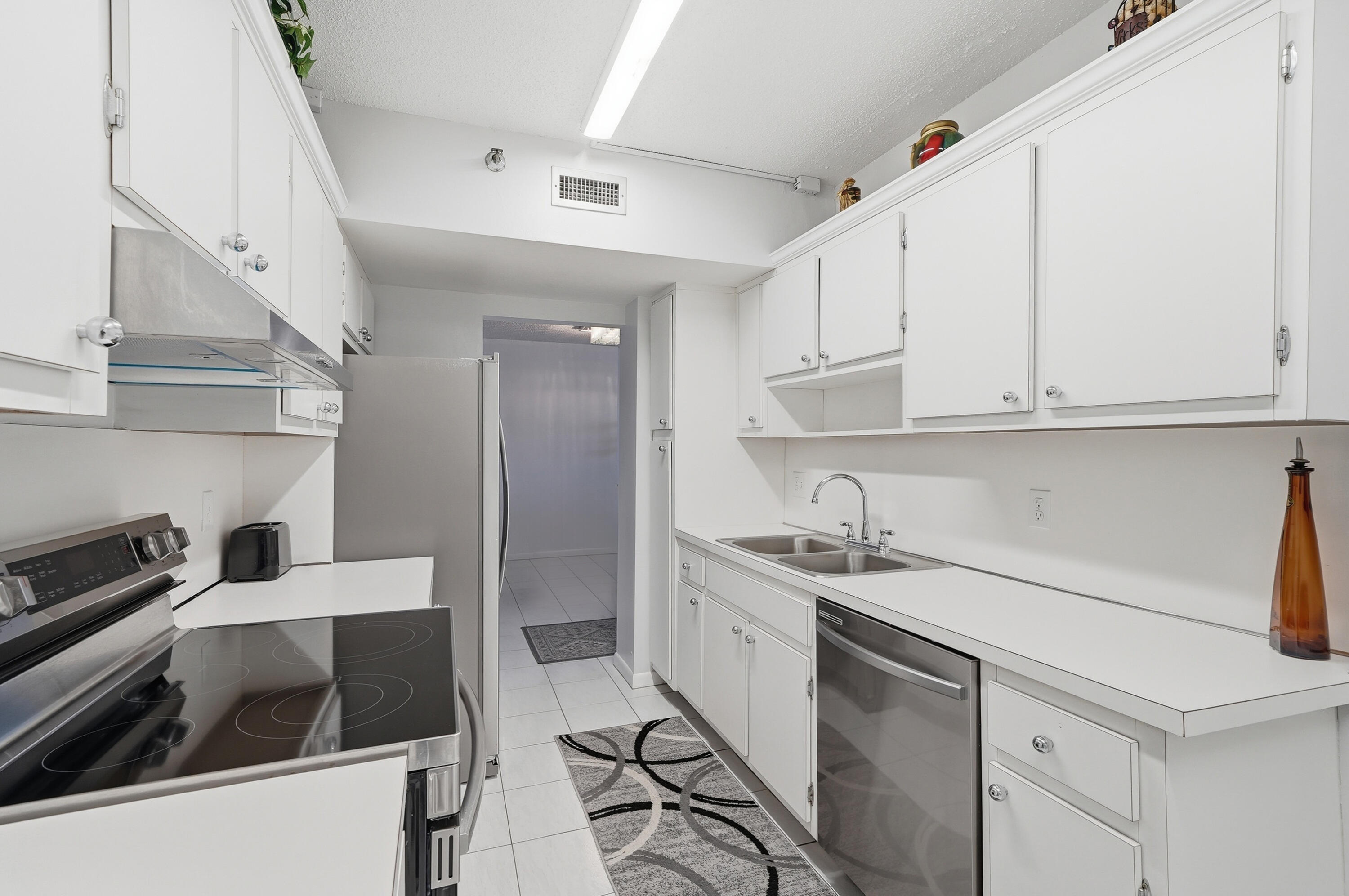 3850 Washington Street, Unit 1003 Hollywood, FL 33021 - Photo 11 of 30 a kitchen with a sink and cabinets