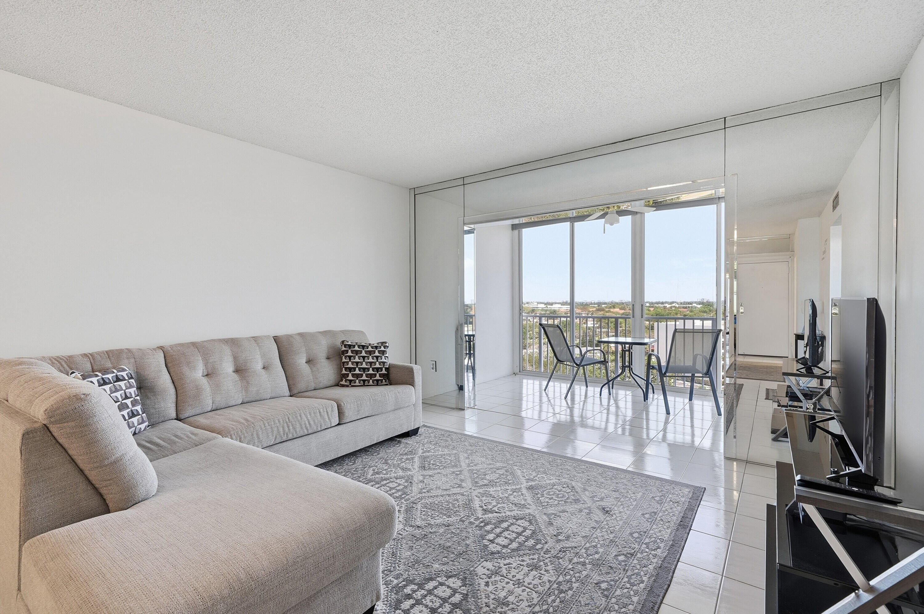 3850 Washington Street, Unit 1003 Hollywood, FL 33021 - Photo 14 of 30 a living room with furniture and a flat screen tv