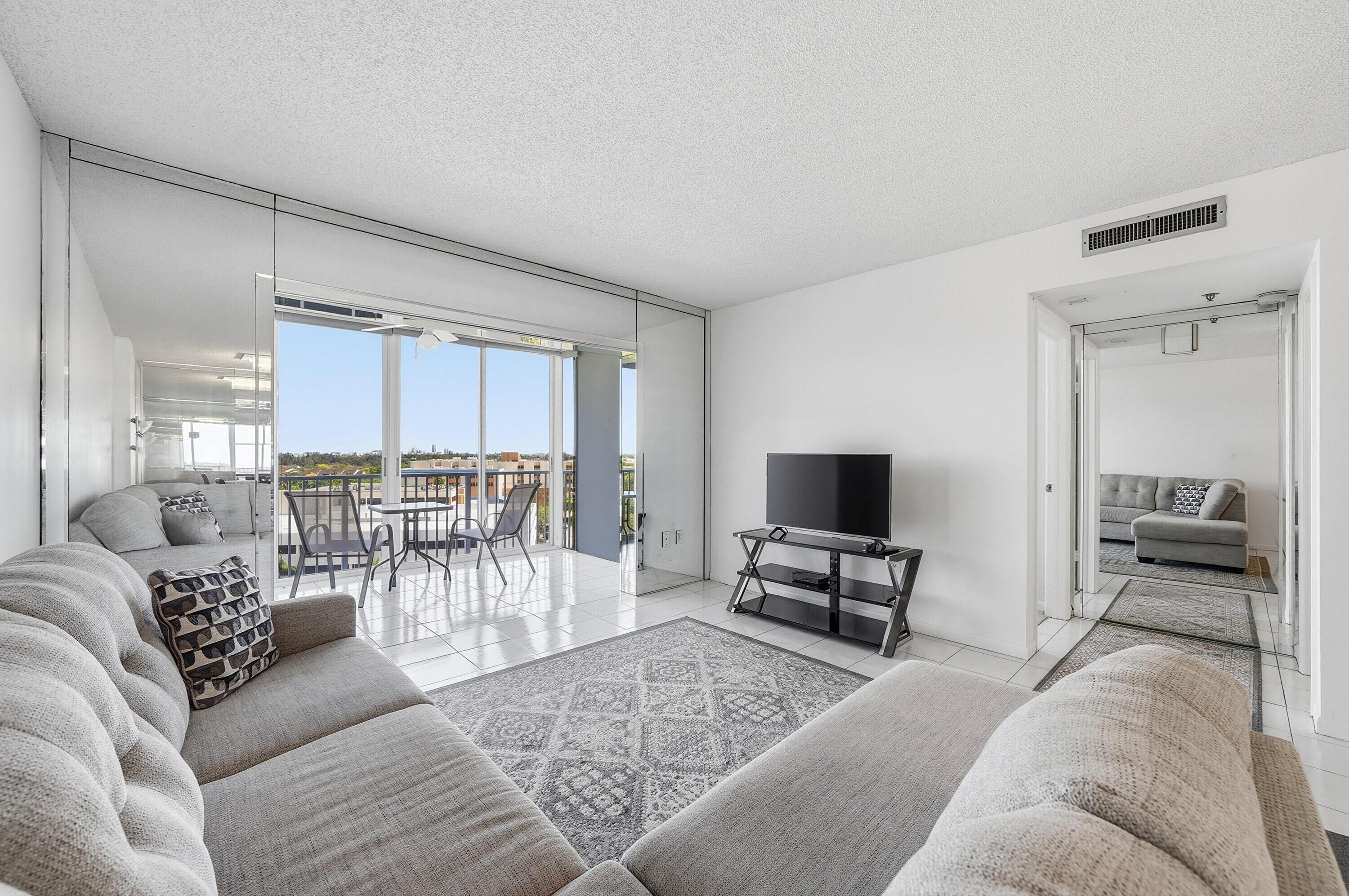 3850 Washington Street, Unit 1003 Hollywood, FL 33021 - Photo 15 of 30 a living room with furniture and a flat screen tv