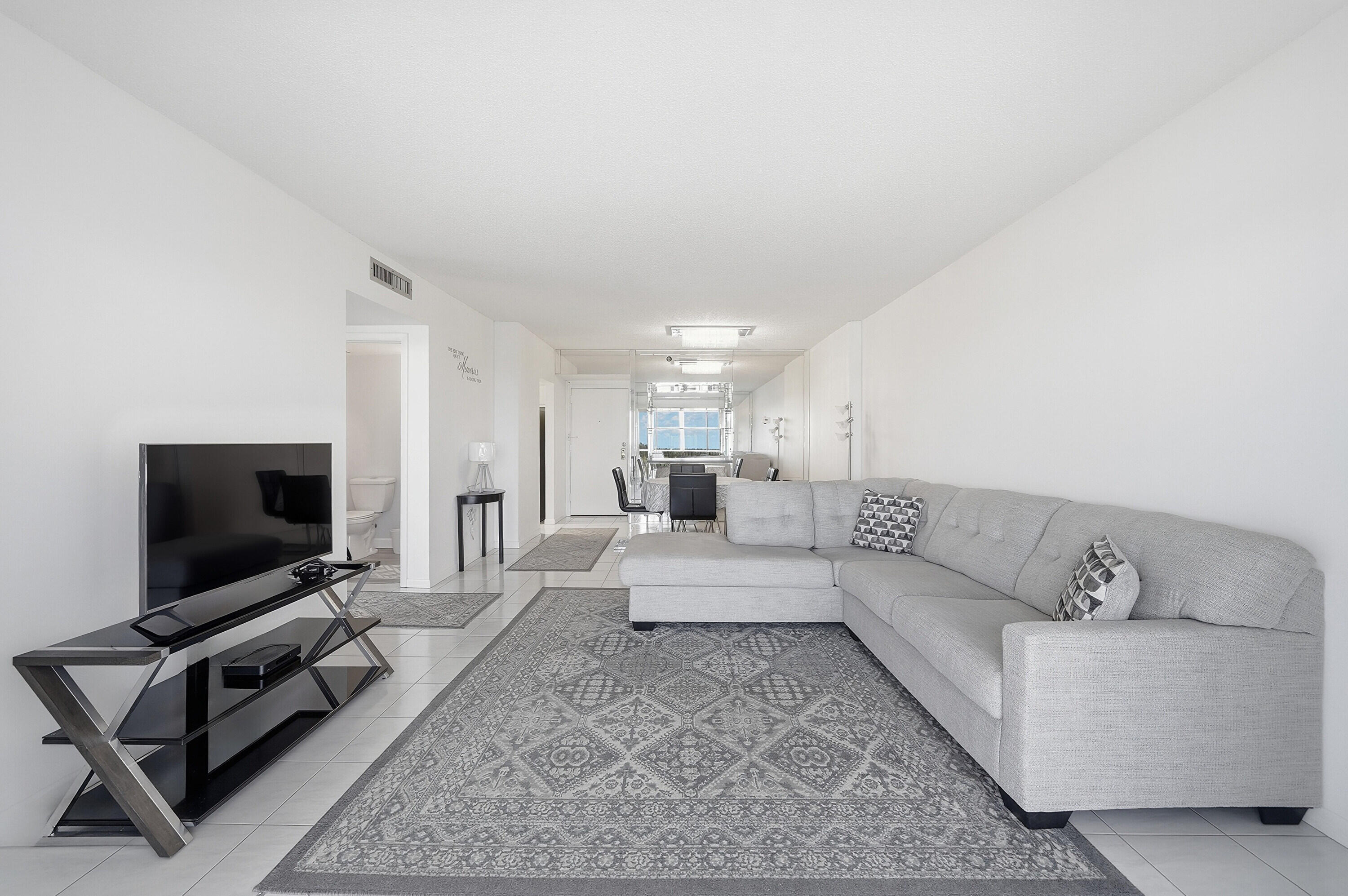 3850 Washington Street, Unit 1003 Hollywood, FL 33021 - Photo 16 of 30 a living room with furniture and a flat screen tv