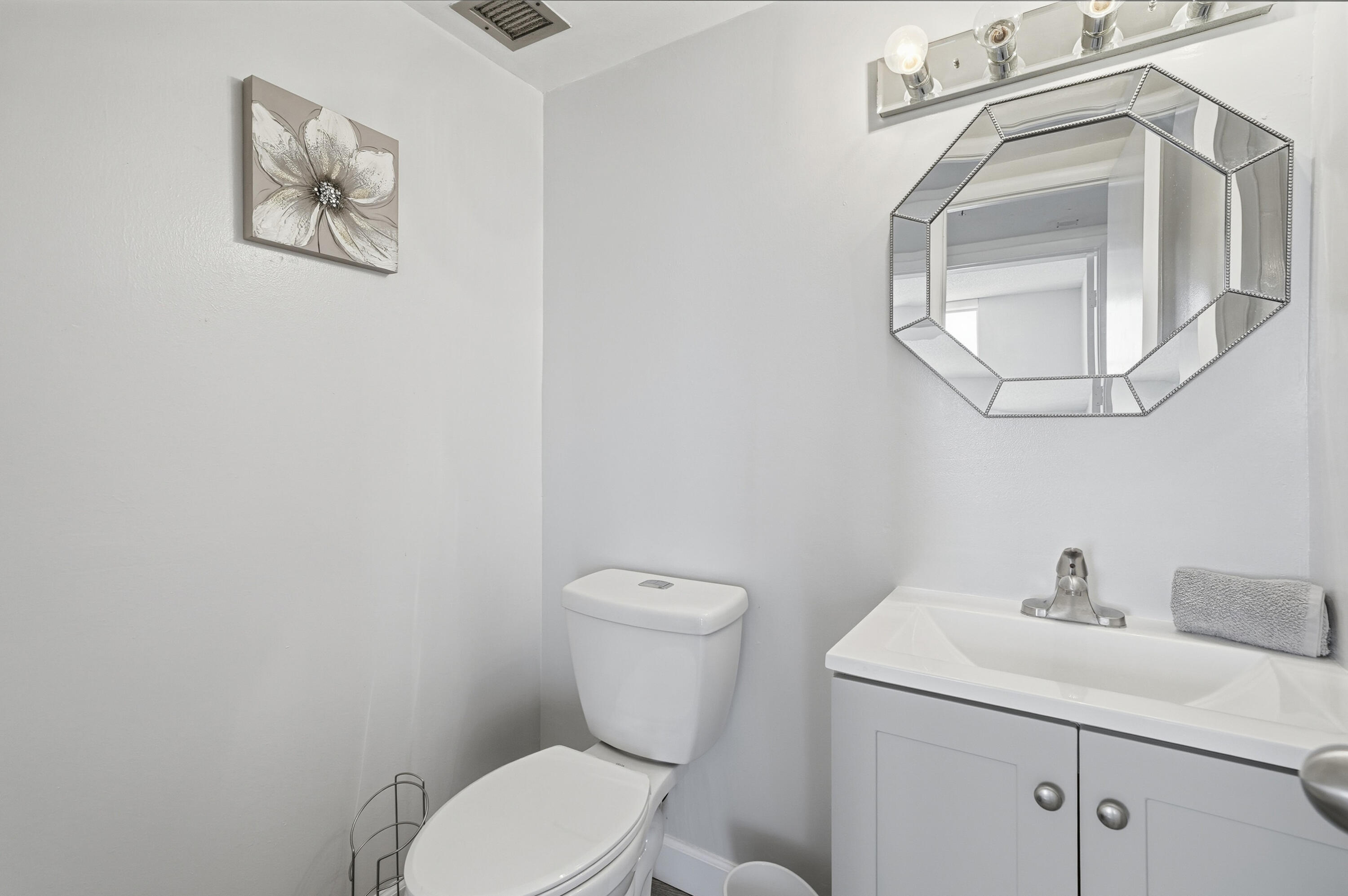 3850 Washington Street, Unit 1003 Hollywood, FL 33021 - Photo 20 of 30 a bathroom with a toilet sink and mirror