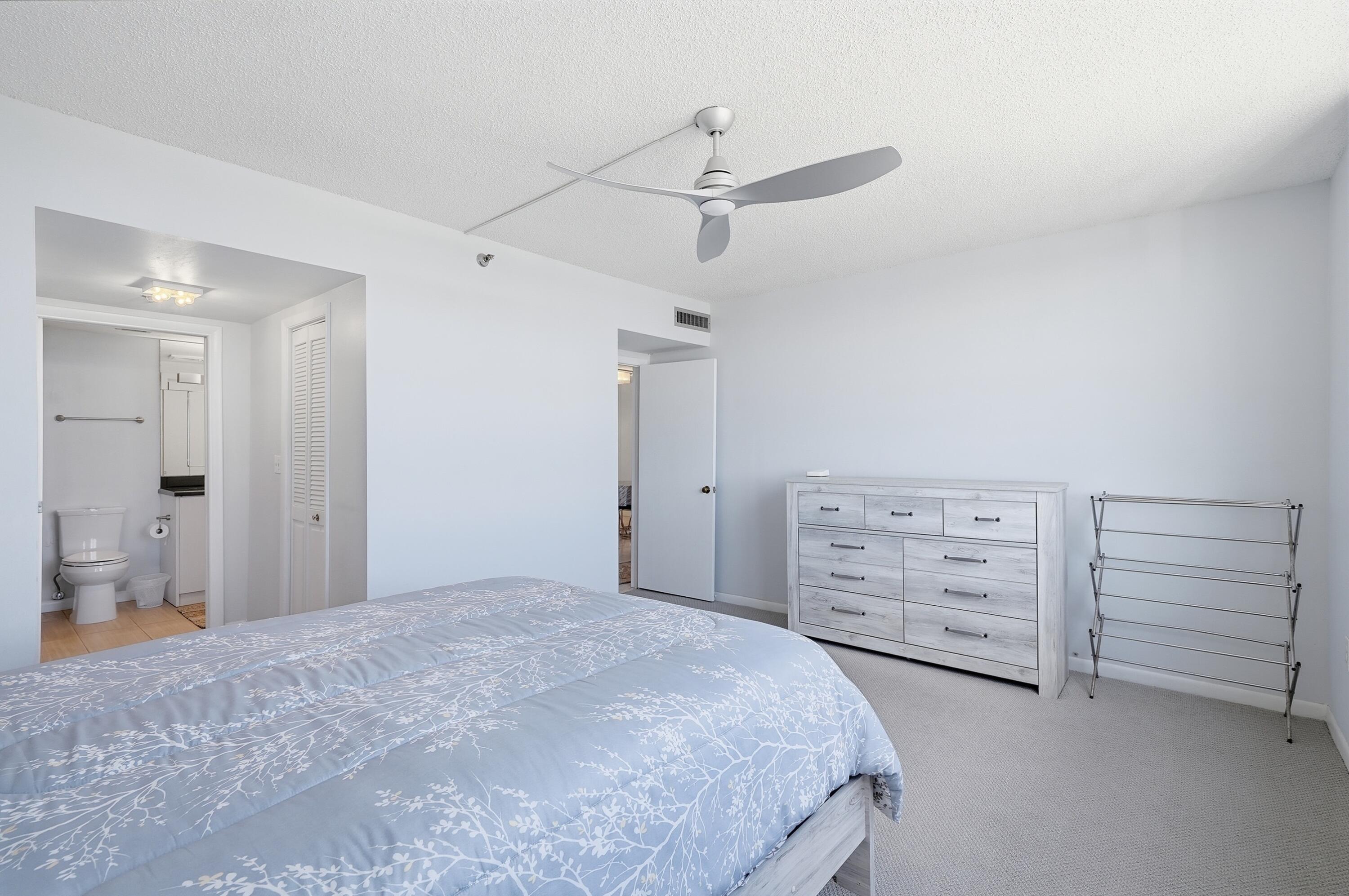 3850 Washington Street, Unit 1003 Hollywood, FL 33021 - Photo 23 of 30 a bedroom with a bed and cabinets