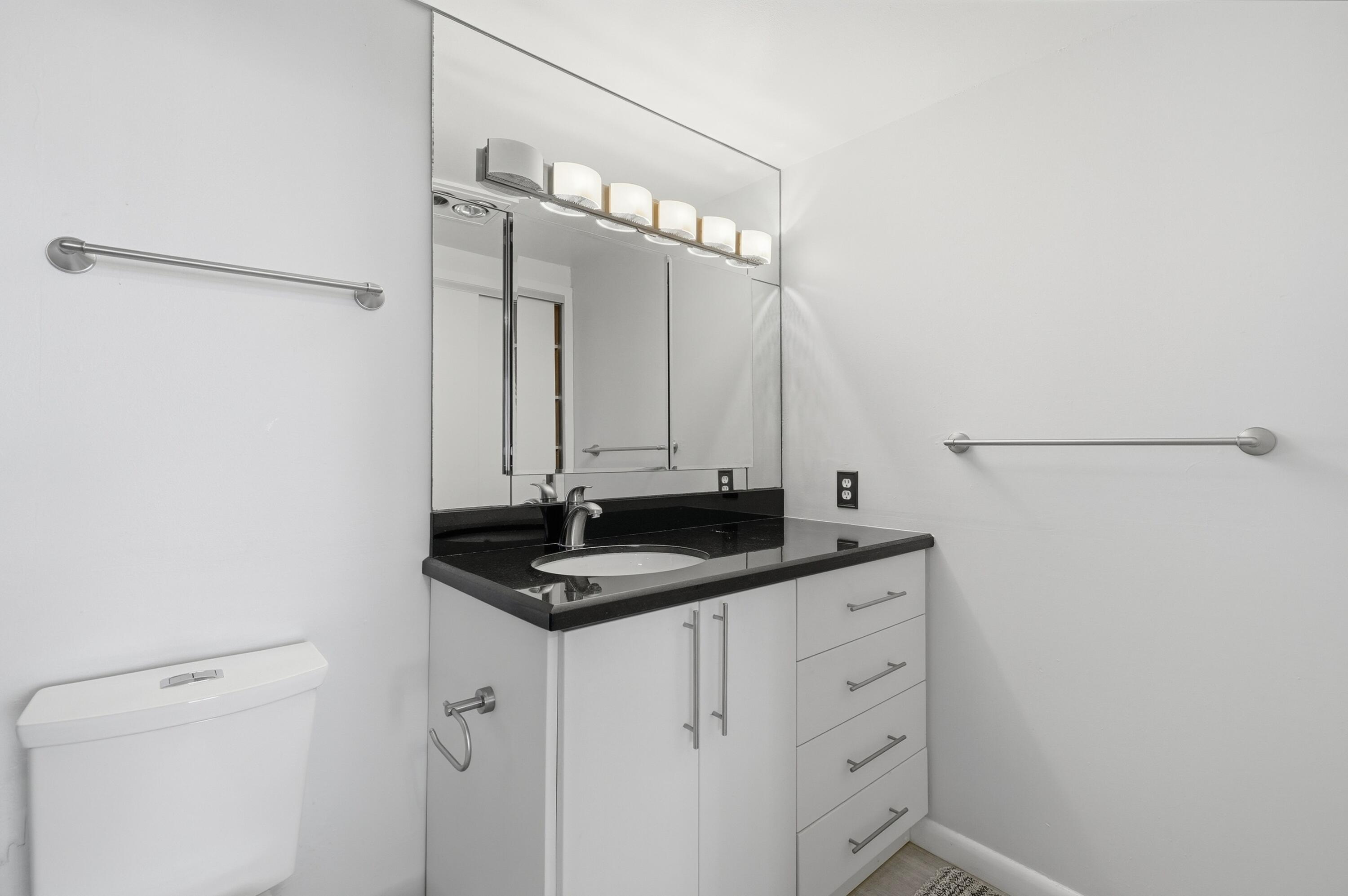 3850 Washington Street, Unit 1003 Hollywood, FL 33021 - Photo 25 of 30 a bathroom with a granite countertop sink and a mirror