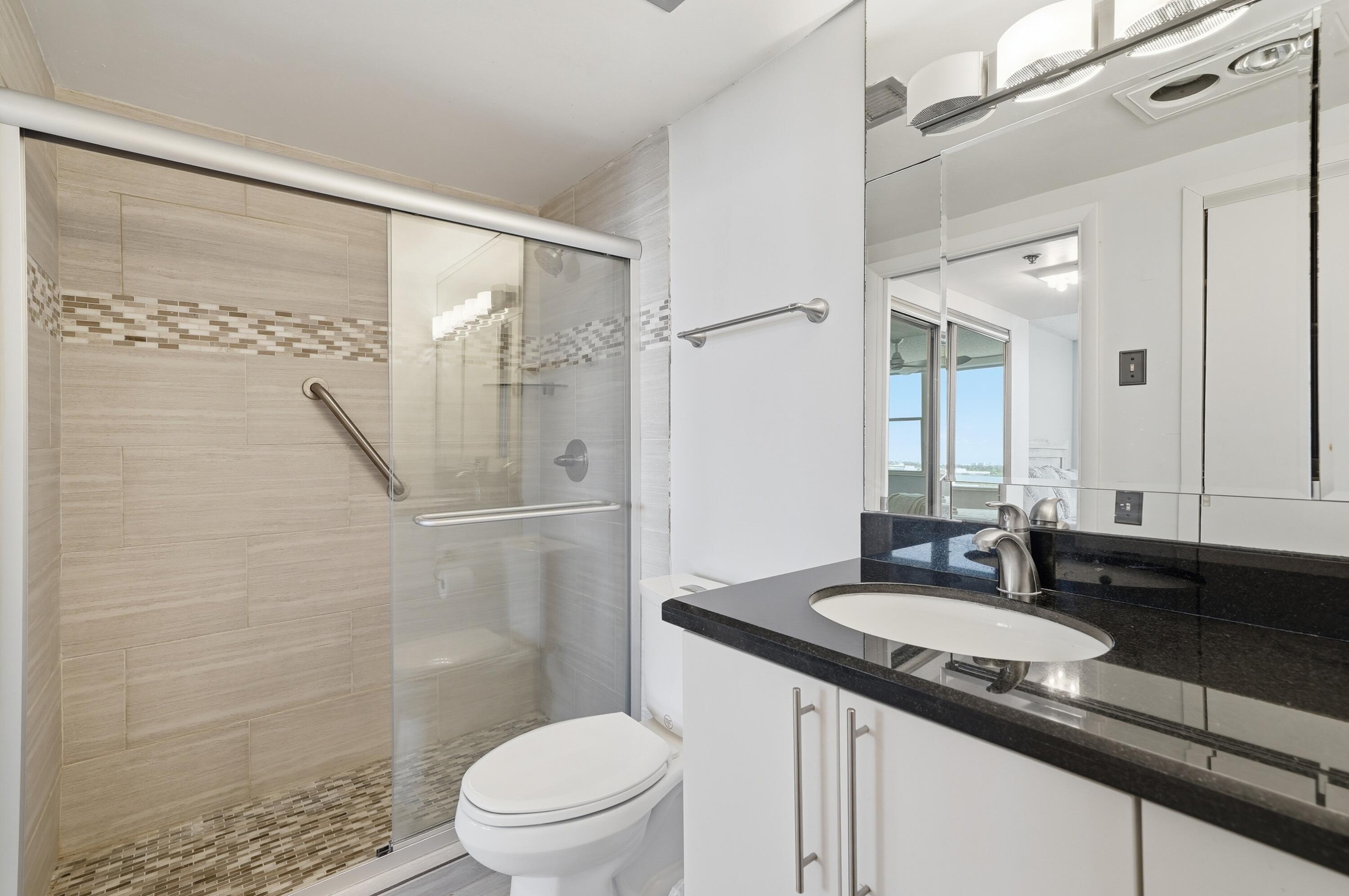 3850 Washington Street, Unit 1003 Hollywood, FL 33021 - Photo 26 of 30 a bathroom with a granite countertop sink toilet and shower