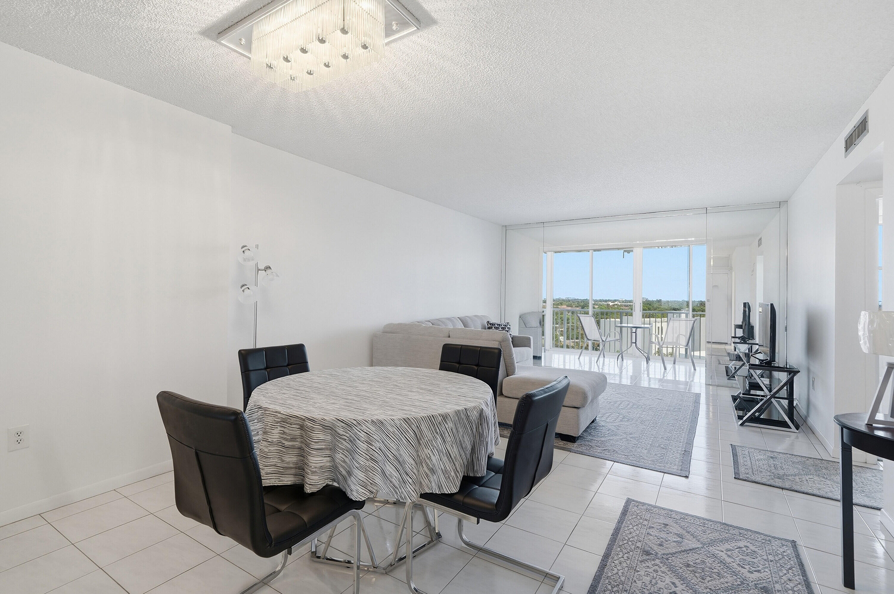 3850 Washington Street, Unit 1003 Hollywood, FL 33021 - Photo 5 of 30 a bedroom with furniture and a chandelier