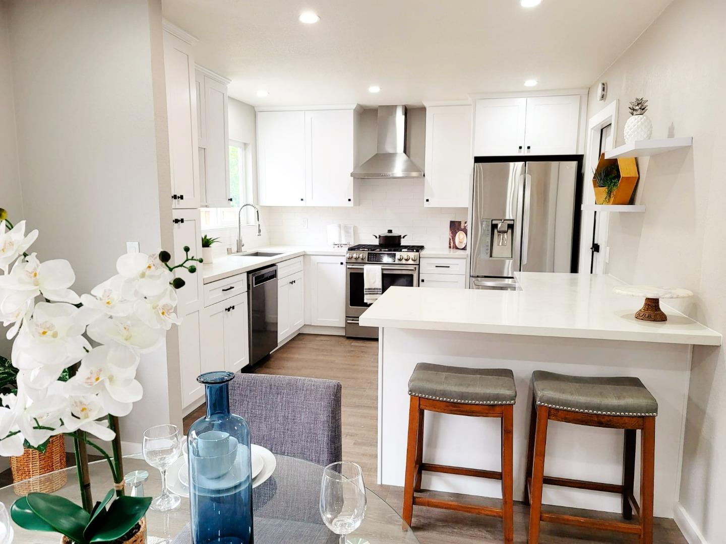 7439 Blue Fox Way San Ramon, CA 94583 - Photo 8 of 19 a kitchen with stainless steel appliances a stove a sink cabinets and a refrigerator