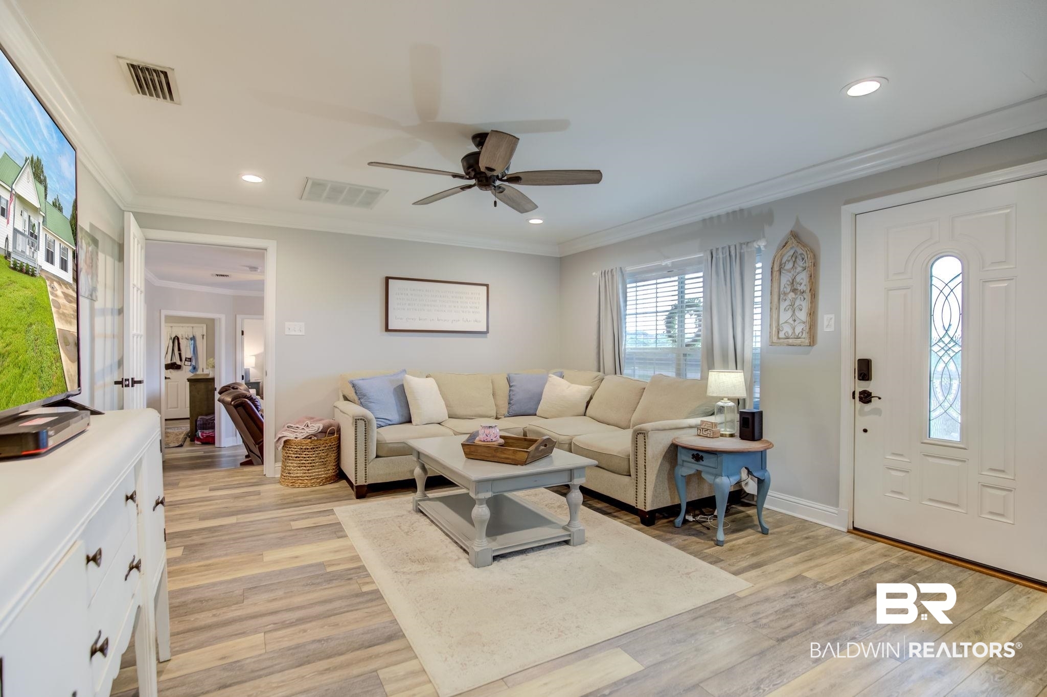 18732 Fairground Road Robertsdale, AL 36567 - Photo 8 of 46 Living room featuring light hardwood / wood-style flooring, ornamental molding, and ceiling fan
