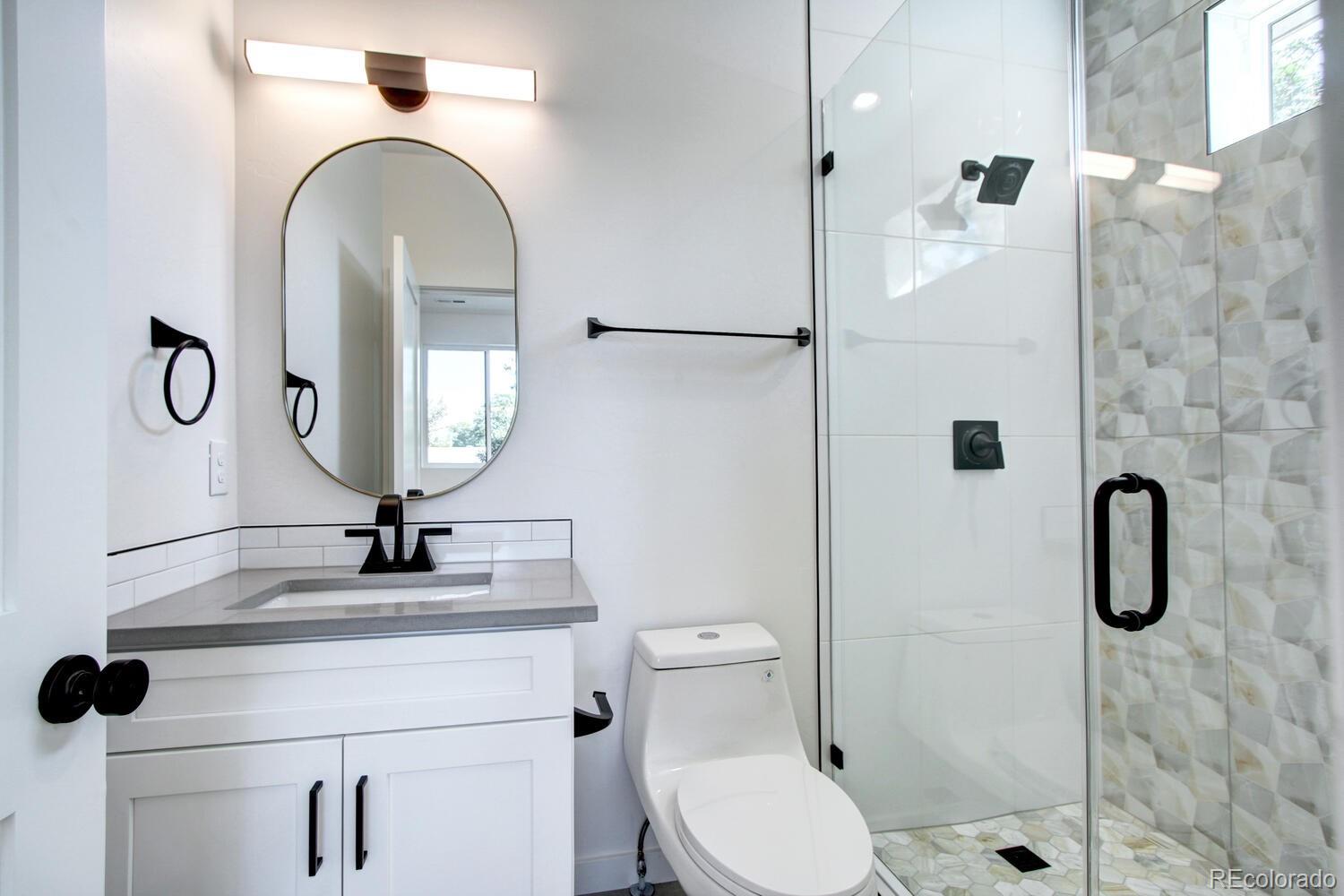 4128 Chase Street Denver, CO 80212 - Photo 21 of 42 a bathroom with a toilet sink and shower