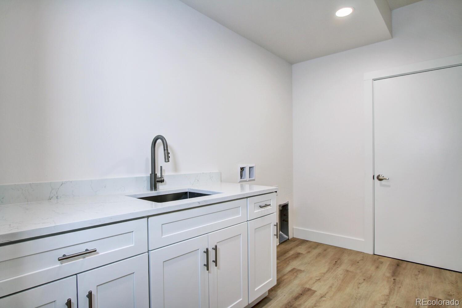 4128 Chase Street Denver, CO 80212 - Photo 25 of 42 a kitchen with a sink and cabinets