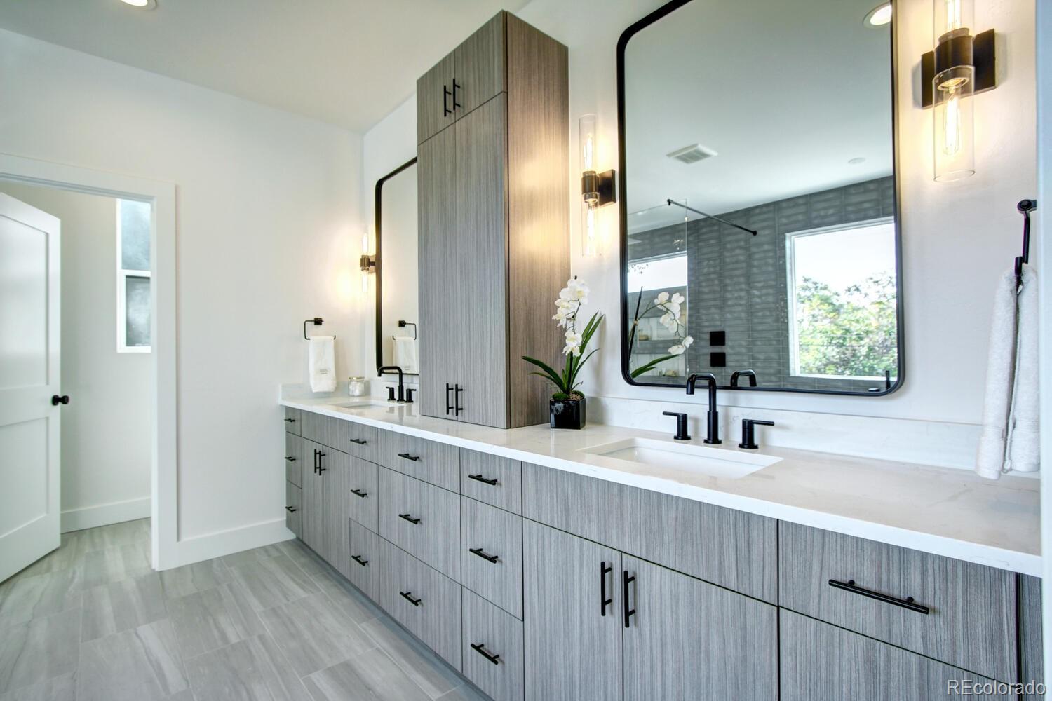 4128 Chase Street Denver, CO 80212 - Photo 29 of 42 a bathroom with a double vanity sink and mirror