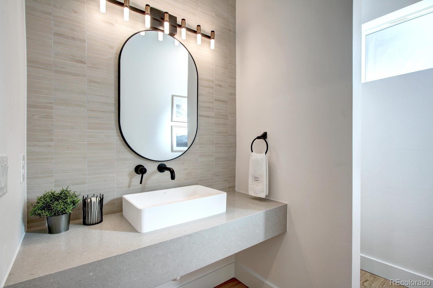 4128 Chase Street Denver, CO 80212 - Photo 8 of 42 a bathroom with a sink mirror and vanity