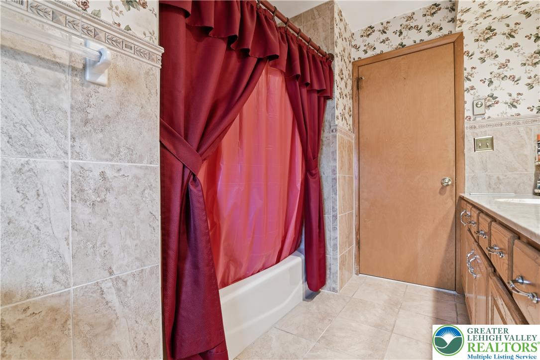 3303 Barklay Road Whitehall, PA 18052 - Photo 29 of 39 Functional bathroom featuring a shower-tub combination and ample vanity space.
