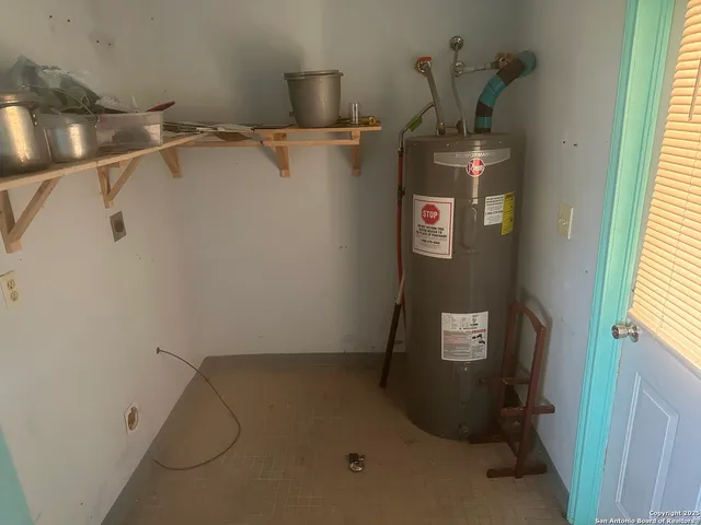 a kitchen with a sink a stove and a microwave