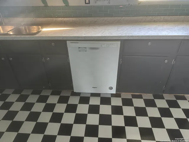 a stove top oven sitting inside of a kitchen