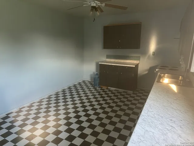 a kitchen with a sink a stove and cabinets