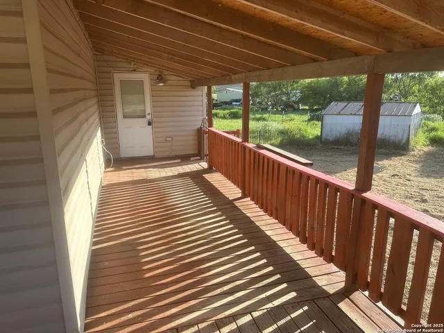 a view of a porch with wooden floor