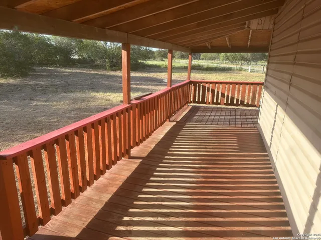 a view of balcony with wooden floor