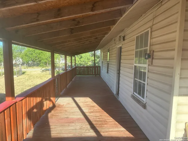 a view of balcony with wooden floor