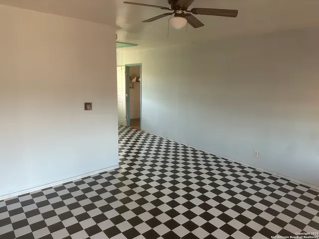 a living room with a black white checkered floor