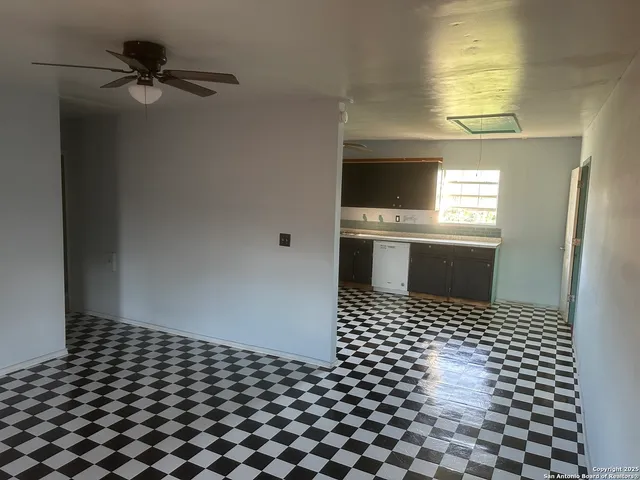 a kitchen with a sink a stove and cabinets