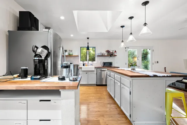a kitchen with stainless steel appliances kitchen island granite countertop a sink and cabinets