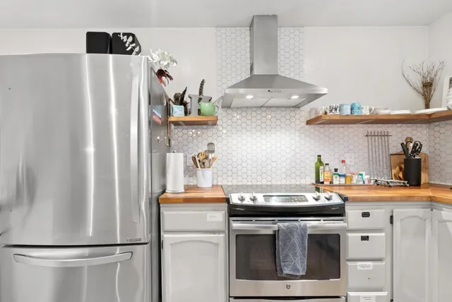 a kitchen with stainless steel appliances a refrigerator and a stove