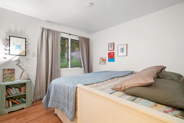 a bedroom with a bed and a window