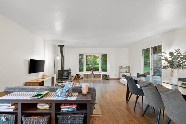 a living room with furniture a window and a flat screen tv