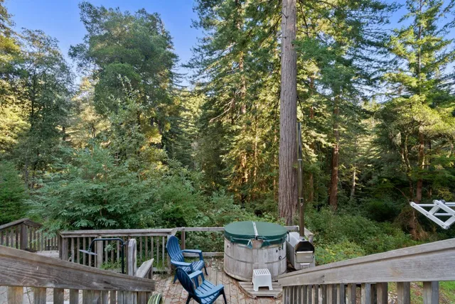 a view of outdoor sitting area with furniture and wooden fence