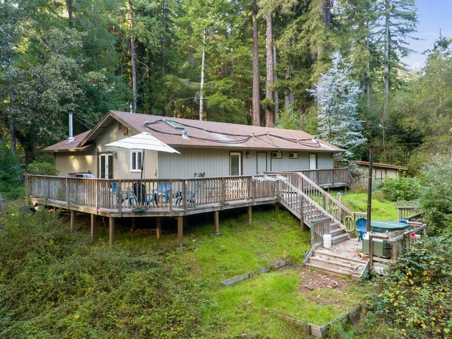 a balcony with wooden floor table and chairs