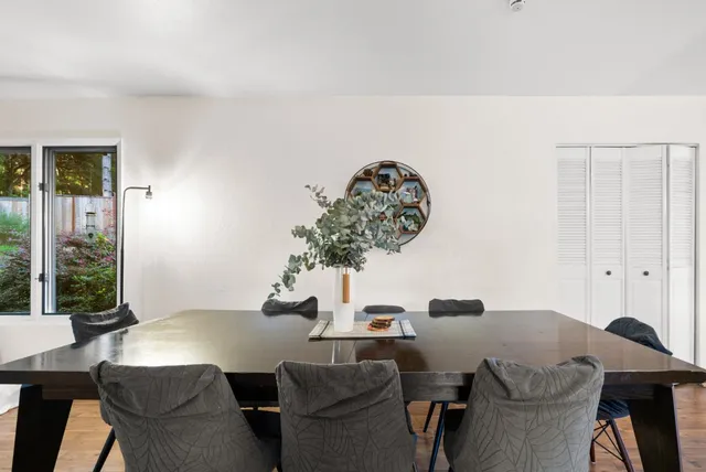 a view of a dining room with furniture and window