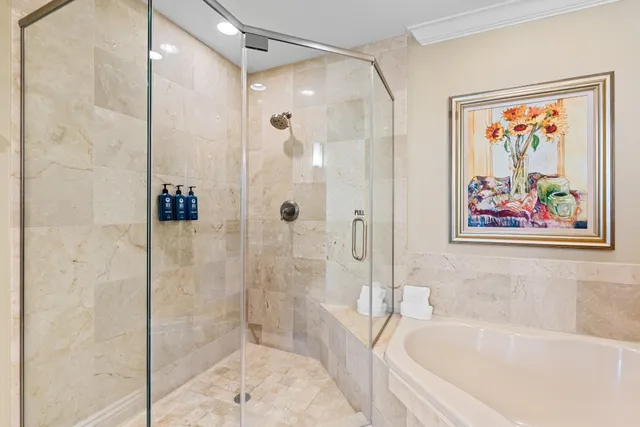 a bathroom with a granite countertop sink and a bathtub