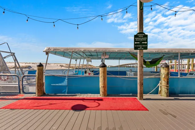 a view of a patio with a table and chairs under an umbrella