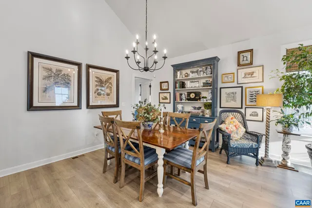 a view of a dining room with furniture and chandelier