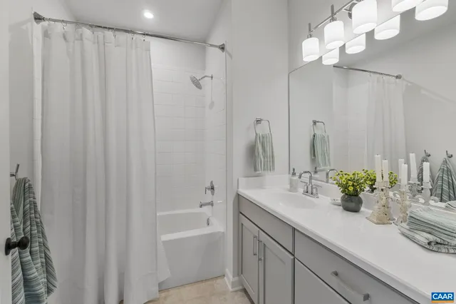 a bathroom with a sink a mirror and a shower curtain