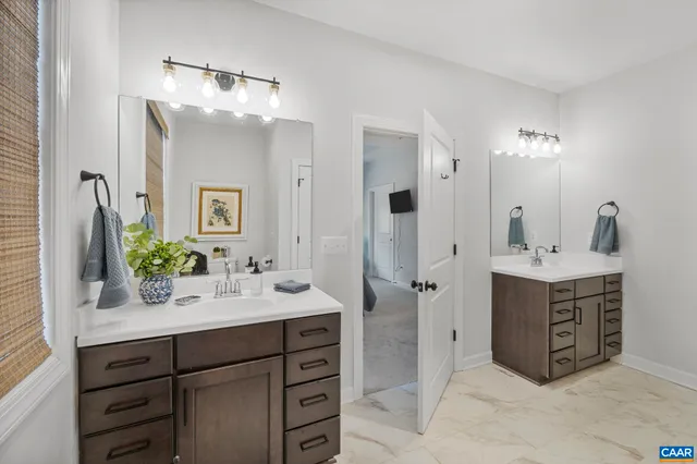 a bathroom with a sink vanity and mirror
