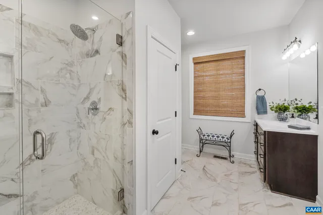 a bathroom with a shower sink and mirror